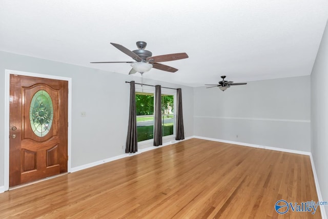 entryway with ceiling fan and light hardwood / wood-style floors