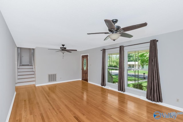 unfurnished living room featuring ceiling fan and light hardwood / wood-style floors