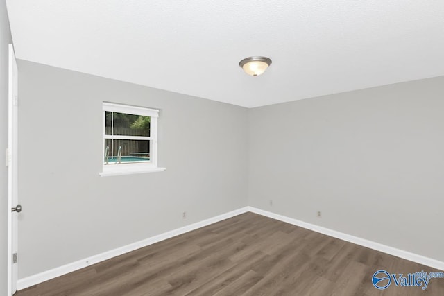 empty room featuring dark wood-type flooring