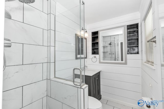 bathroom with vanity, ornamental molding, an enclosed shower, and toilet