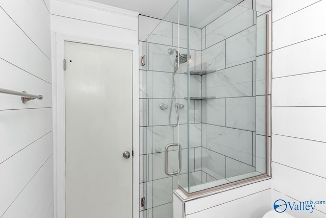 bathroom with a shower with door