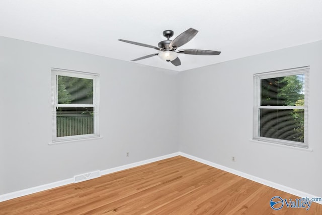 spare room with hardwood / wood-style flooring and ceiling fan