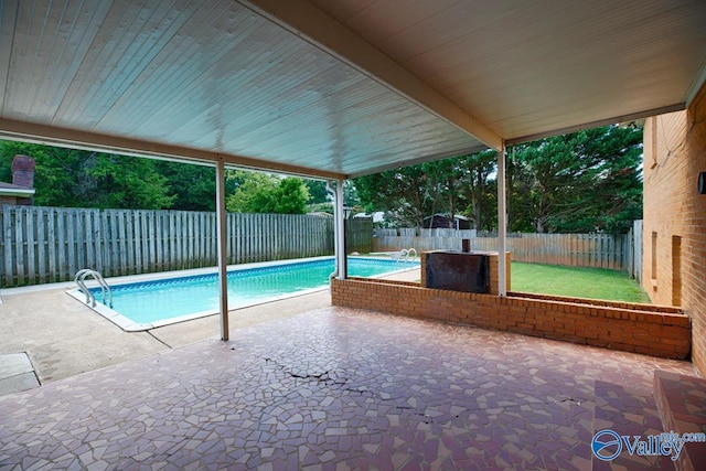 view of swimming pool with a patio area