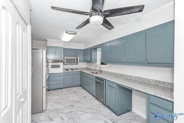 kitchen with blue cabinetry, sink, a textured ceiling, ceiling fan, and stainless steel appliances