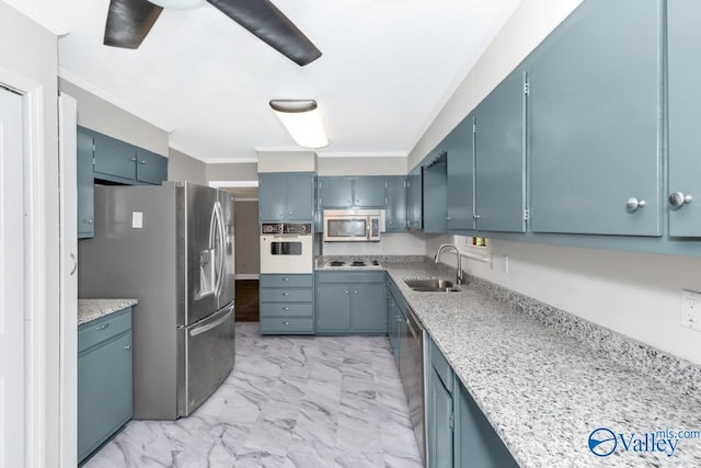 kitchen featuring blue cabinetry, sink, light stone counters, ornamental molding, and appliances with stainless steel finishes