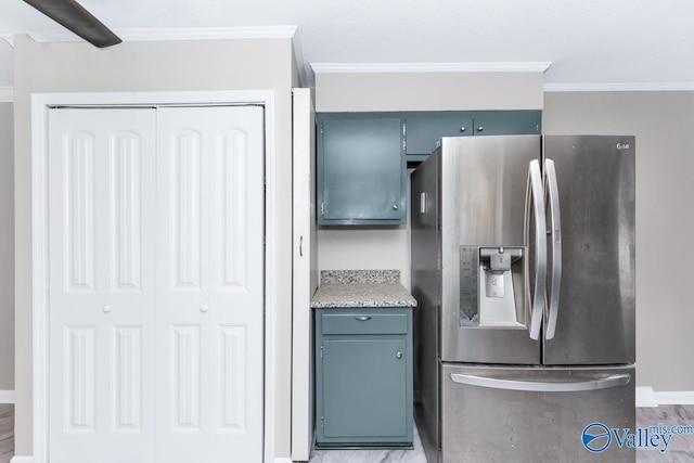 kitchen featuring stainless steel fridge and ornamental molding