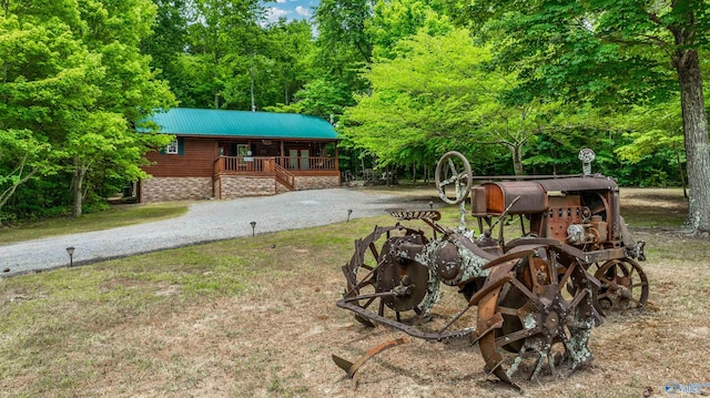 view of yard featuring covered porch