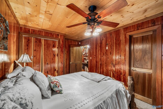 bedroom with wood ceiling, ceiling fan, wooden walls, and a closet