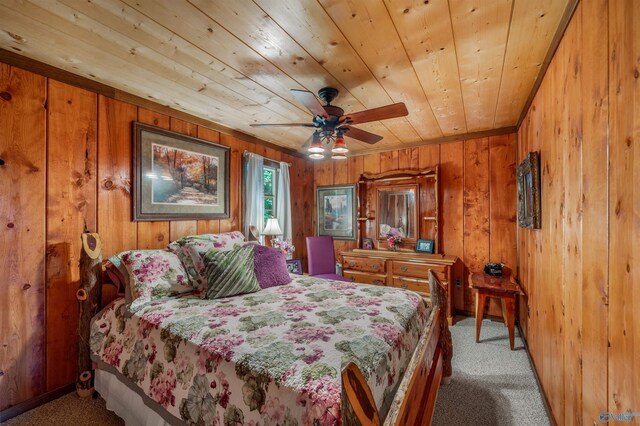 bedroom with wood walls, wood ceiling, carpet floors, and ceiling fan