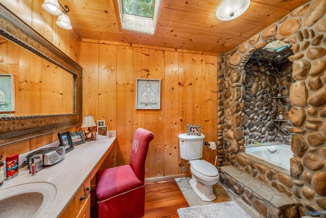 bathroom with wood walls, toilet, wooden ceiling, and a skylight