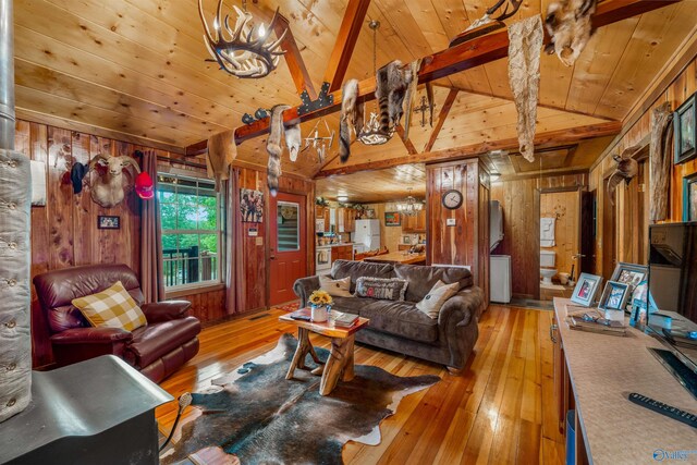 living room with wood walls, light hardwood / wood-style flooring, wood ceiling, and vaulted ceiling with beams