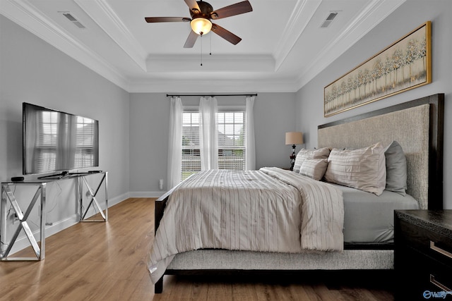 17092 Obsidian Cir, Athens, AL 35613 - bedroom featuring a raised ceiling, wood finished floors, ornamental molding, a ceiling fan, and baseboards