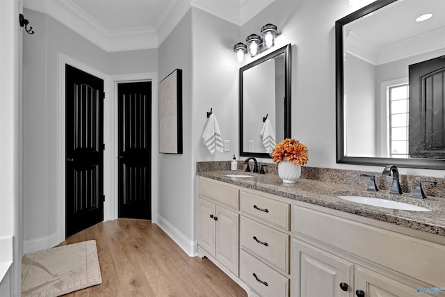 17092 Obsidian Cir, Athens, AL 35613 - bathroom featuring wood finished floors, ornamental molding, double vanity, and baseboards