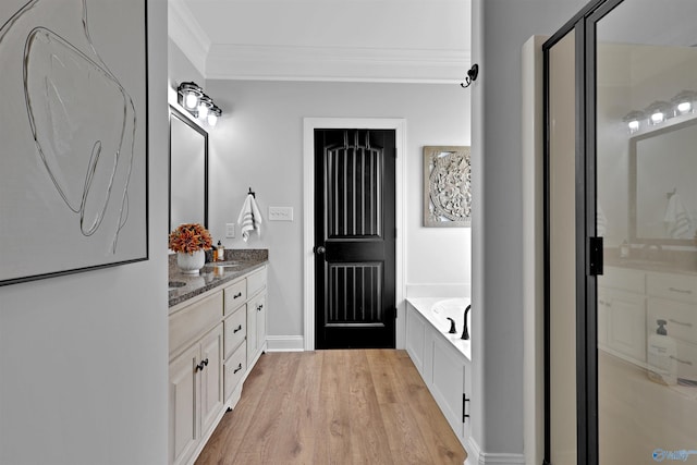 17092 Obsidian Cir, Athens, AL 35613 - bathroom with ornamental molding, a garden tub, vanity, and wood finished floors