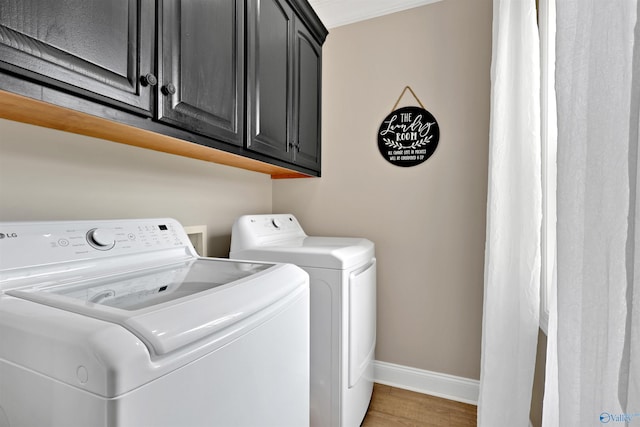 17092 Obsidian Cir, Athens, AL 35613 - laundry area featuring separate washer and dryer, baseboards, cabinet space, light wood-style flooring, and crown molding