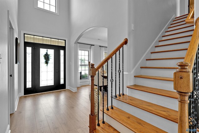 17092 Obsidian Cir, Athens, AL 35613 - entrance foyer featuring a high ceiling, arched walkways, healthy amount of natural light, baseboards, and stairway