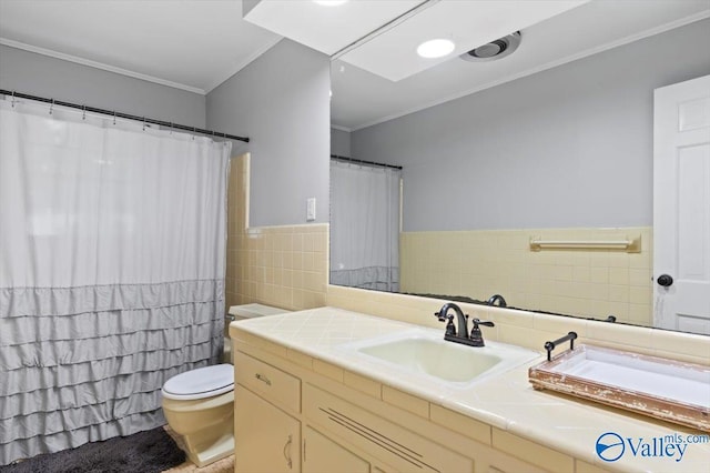 full bath featuring vanity, toilet, a wainscoted wall, tile walls, and ornamental molding