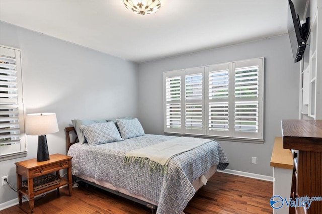 bedroom featuring baseboards and wood finished floors