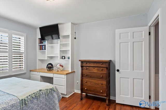 bedroom with dark wood-type flooring
