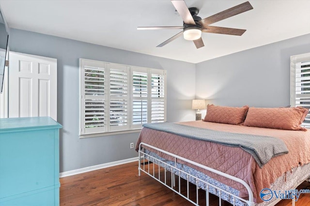 bedroom featuring baseboards, ceiling fan, and wood finished floors