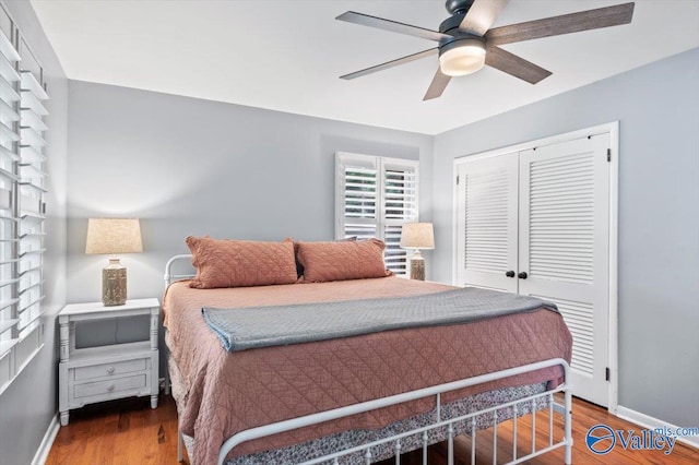 bedroom featuring baseboards, a closet, and wood finished floors