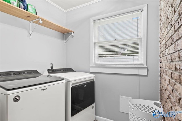 laundry room featuring laundry area, crown molding, and washer and dryer