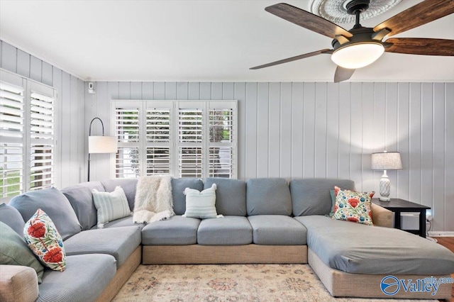 living room featuring a ceiling fan and wood finished floors