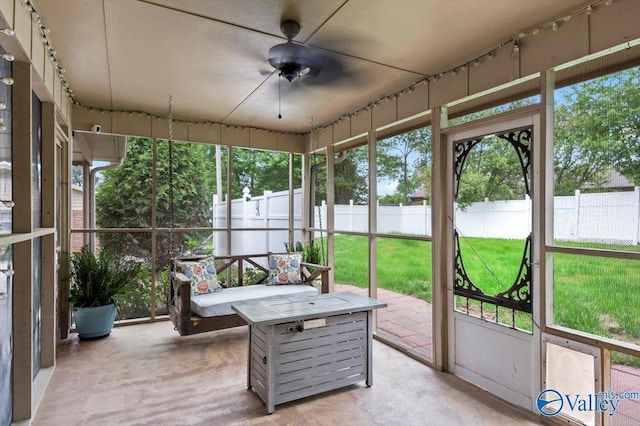sunroom / solarium featuring ceiling fan