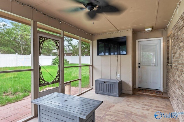 sunroom featuring ceiling fan and a wealth of natural light