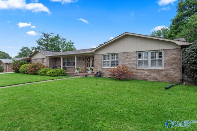 ranch-style house with brick siding and a front lawn