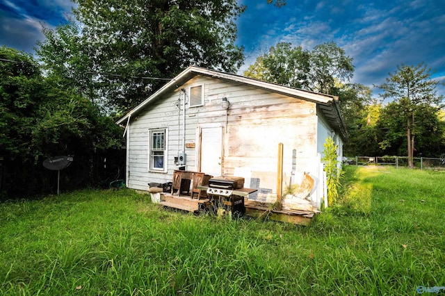 view of outbuilding featuring a lawn