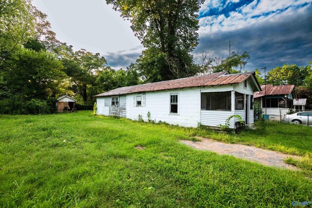 view of side of property with a yard