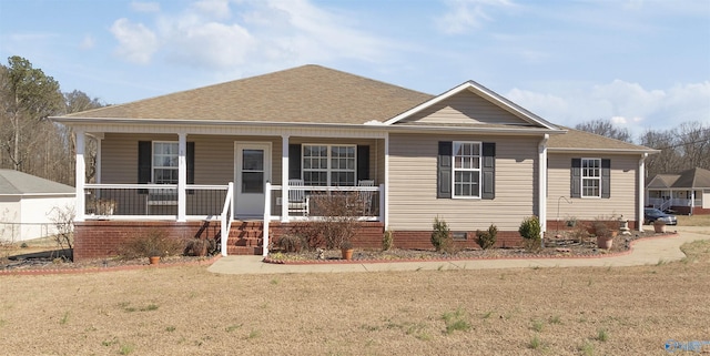 view of front of home with a front yard, covered porch, roof with shingles, and crawl space