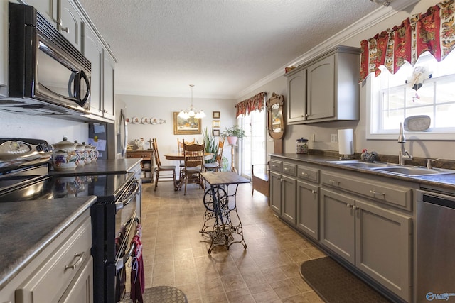 kitchen featuring dark countertops, plenty of natural light, appliances with stainless steel finishes, and a sink