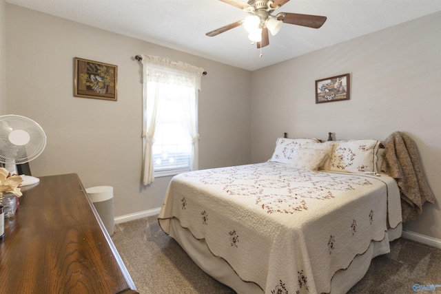 carpeted bedroom with a ceiling fan and baseboards