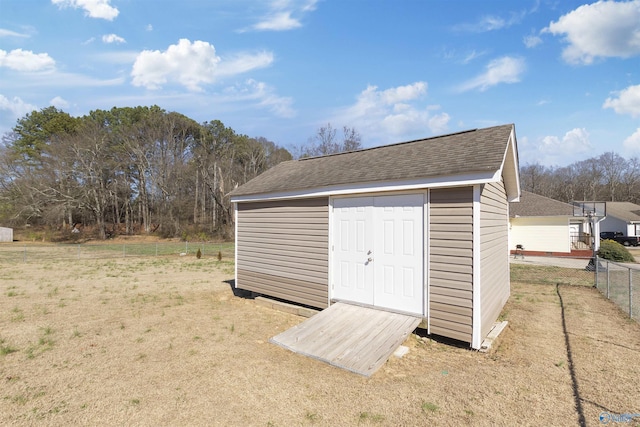 view of shed featuring fence