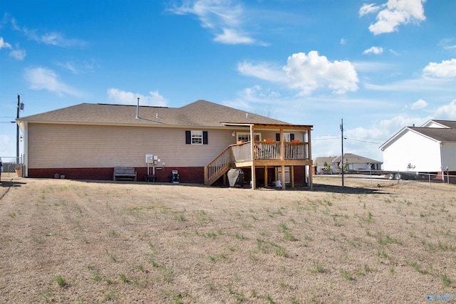 back of house featuring a deck, a yard, stairway, and fence