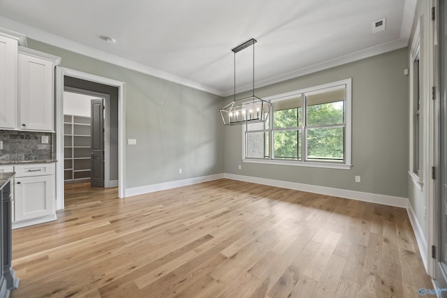 78 Mcmullen Ln SE, Gurley, AL 35748 - unfurnished dining area with ornamental molding, a chandelier, baseboards, and light wood-style flooring