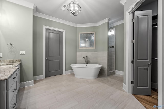 78 Mcmullen Ln SE, Gurley, AL 35748 - full bath featuring a soaking tub, vanity, a chandelier, ornamental molding, and baseboards