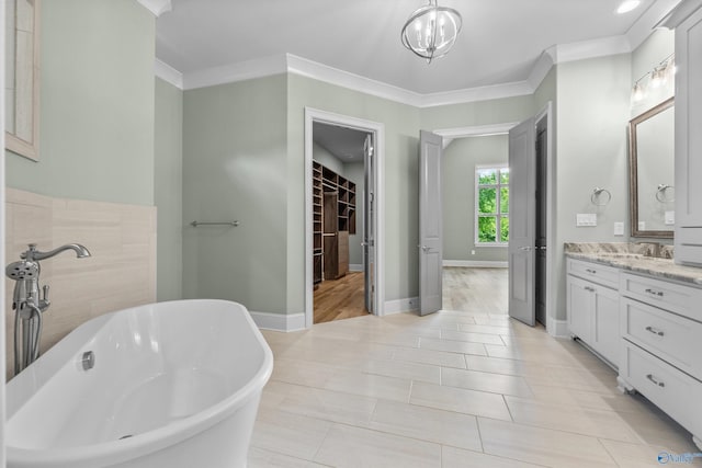 78 Mcmullen Ln SE, Gurley, AL 35748 - full bath with vanity, a freestanding bath, crown molding, a spacious closet, and baseboards