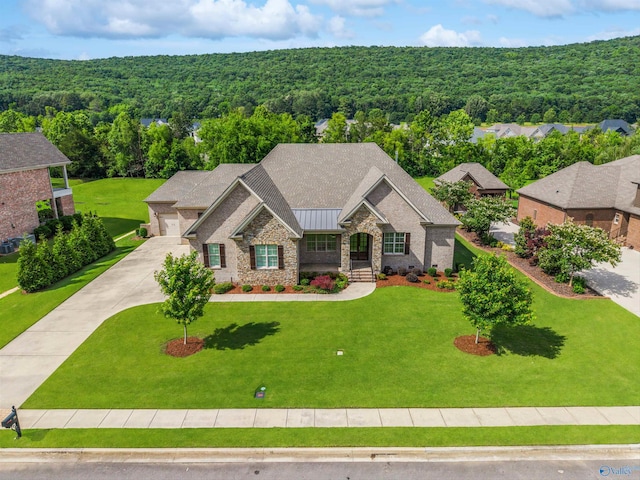 78 Mcmullen Ln SE, Gurley, AL 35748 - view of front of house featuring a wooded view, stone siding, a front lawn, and a standing seam roof