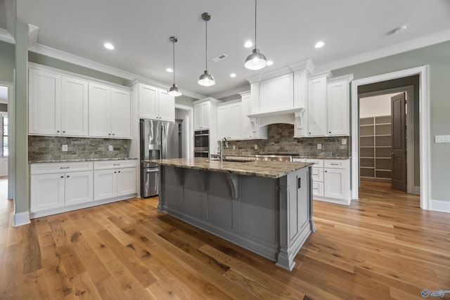 78 Mcmullen Ln SE, Gurley, AL 35748 - kitchen with a sink, appliances with stainless steel finishes, tasteful backsplash, white cabinetry, and ornamental molding
