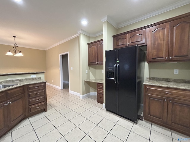 kitchen with dark brown cabinetry, black fridge with ice dispenser, built in desk, and decorative light fixtures