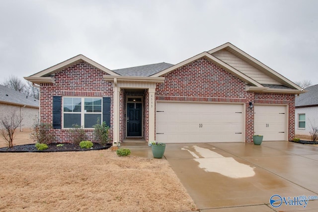 ranch-style home featuring concrete driveway, a garage, and brick siding