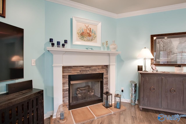 interior space with crown molding, wood finished floors, baseboards, and a fireplace with raised hearth