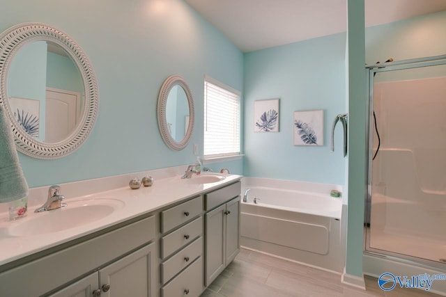 full bath featuring a bath, a shower stall, double vanity, and a sink