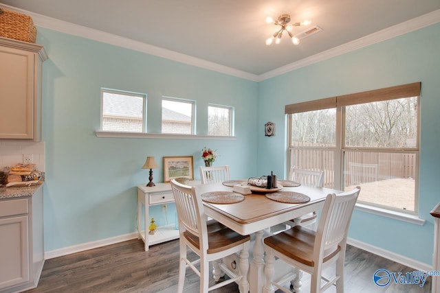 dining room with dark wood-style floors, crown molding, and baseboards