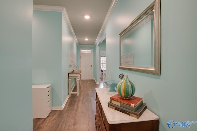 hallway featuring recessed lighting, baseboards, wood finished floors, and crown molding