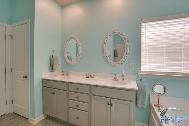 full bath featuring double vanity and a sink