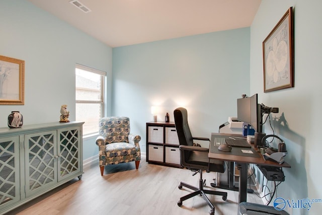 office area featuring wood finished floors, visible vents, and baseboards